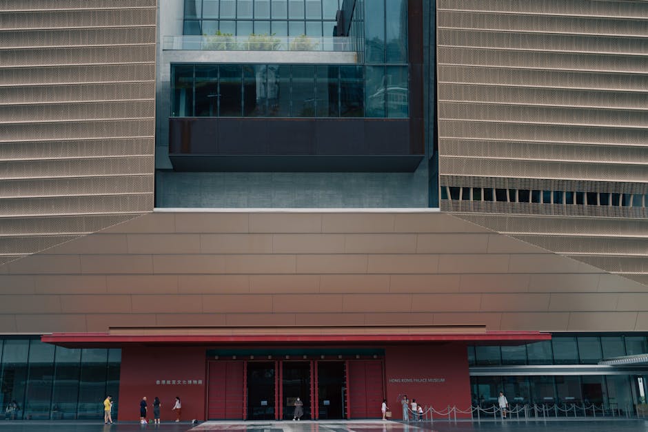Front view of the Hong Kong Palace Museum showcasing its modern design and visitors.