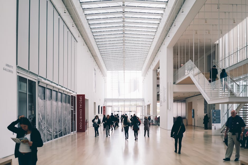 Spacious art gallery lobby with visitors in a modern architectural setting.